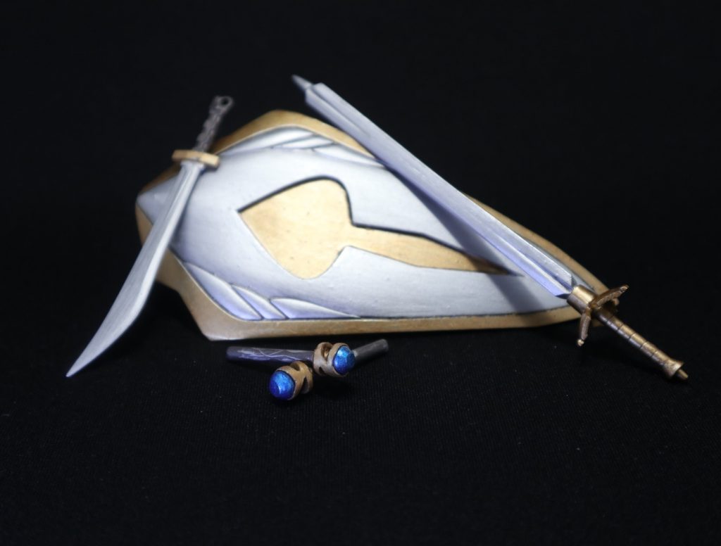 武装は、主兵装となる三角錐が特徴的なロングソード、ラージシールド、マジックロッドx2(背中のアームに懸架)、副兵装として、ショートソードをシールド裏面に配備