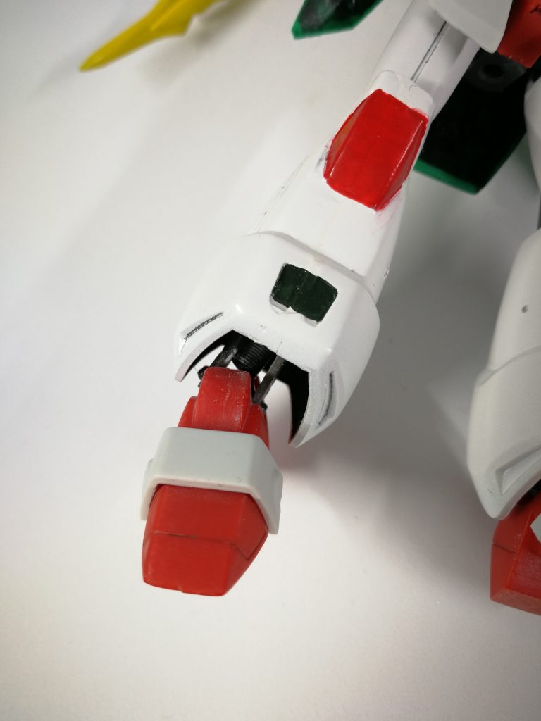 足首関節の仕込みに一番苦労しました。
HGUCザク２の足首関節を参考に、引き出し式の3重関節にしました。
パーツ形状からして足首の稼働が制限されやすいのですが、引き出し式にすることで干渉部分から足首を引き出せるようにし、克服しています。


脛裏に第一関節を接着していましたが、ガイドや角のない場所へ貼り付けが難しくしっかり固定できませんでした。
そこで、第一関節のポリキャップ～足の左右パーツの外まで真鍮線でがっちり繋ぎました。

改造・取り付け作業を5回は繰り返したかなぁ。。。