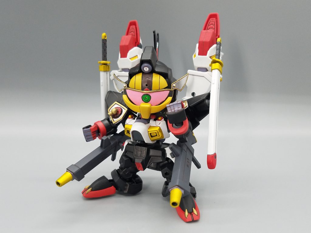 天宮の民衆の前では陰陽師 天獄の羽兵(テンゴクのバーディ)を名乗り空中を浮揚し
影舞乱夢では修験者 愚嵐の歩魅(グランのアーミー)として獣のような怪力を
赤流火穏では呪術師 折堕の鮎尾(オルタのネイビー)として奇怪な体躯で
民衆を煽動し泰平の世を混乱に陥れようと目論んだ仮面の男。
これを危険視した頑駄無軍団は、この神出鬼没な仮面の男を暴流刑之(ヴォルケーノ)と呼称
男の行方を追うことになったが、それは新たな野望との戦いの始まりだったのだ。
大地に残る怨念いわゆる地縛霊を背負うことで、かつて魔界から現れた三羅将の力を自らの肉体で再現する負縛装(オウバクソウ)なる術を使い、頑駄無軍団を襲う!!