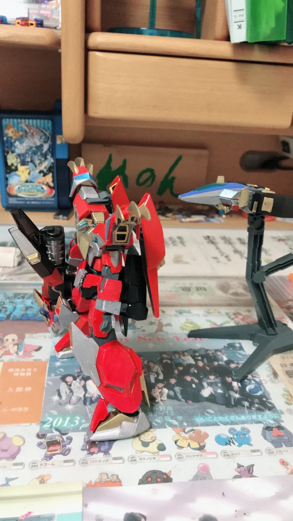 右は戦闘機、コアグリッター
ハイパーエージェントの魂が宿っている。
裏にはドラゴニックガンダムの顔があり、
コレを介してハイパーエージェントと会話も可能
非常時には専用のスマホアプリにコレを
かざすだけで機体と共にGBNにダイブ可能
左はアシストウェポン、キングウェア
GBN内で常時待機状態としてセットされており
コアグリッターの到着と共に目的地に射出
コアグリッターがキングウェアを「着込む」様に
合体する事でドラゴニックガンダムが完成する
原作とは方法が違いますが、この装着合体を
再現するのにウェアシステムはもってこいでした