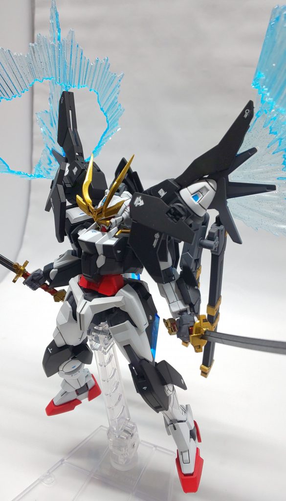 他のガンダムは、非トランザム使用を前提で運用されていますが、本機はグラハムのたっての希望により、トランザムを頻繁に発動出来る設計になっています。
そのため、両肩のGNドライヴはトランザムの為だけに装備されたもの。
よって、トランザム使用後の機体性能の低下は皆無であり、また、トランザム使用時の出力は通常の3.5倍になります。
新型ガンダムの中でも、極めて過剰とも言えるグラハムガンダムのトランザムですが、グラハムは何の苦もなく使いこなしてしまうという、常人には理解できない身体能力を発揮します。
『ガンダムとなったこのグラハムエーカーに、不可能などという言葉は存在しない!!』
とは本人談。
かつてのトランザムは、高濃度圧縮粒子が赤く変色するため機体色がピンク色に発光していましたが、新型GNドライヴSVでは、高濃度圧縮粒子も蒼いままなので、機体色は変わりません。グラハムガンダムの場合、2基のGNドライヴは常時機体内部に高濃度圧縮粒子を蓄積しているため、トランザム発動時にはGN粒子が溢れだすほど出力が上がります。GN粒子を外に放出することで、トランザム発動時は画像の様にGNドライヴから粒子が放出され続けた状態となります。この時、機体のオーバーロードを防ぎ、放出した高濃度圧縮粒子を、機体を包み込む強力なGNフィールドとして機能させています。