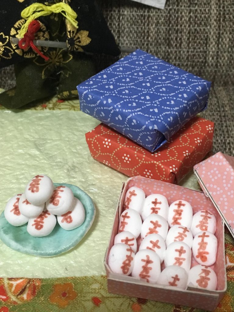 正気の沙汰とはいえない量の十万石饅頭(笑)
全て紙粘土で作り、細いペンで１つ１つ「十万石」と書いています。
お皿も紙粘土で、マニキュア塗装。
贈答用の箱は、厚紙がなかったので紙皿を切って作り、周りに折り紙を貼りました。

ピンセットを無くしたので、
ピンクの贈答用の箱に十万石饅頭を爪先で並べるのがこの作品で1番苦労しました笑
「自分は何をやってるんだろう…」と思った瞬間でしたw