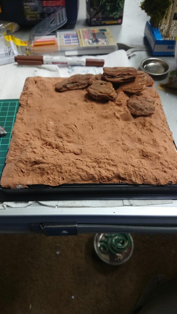 台座は以前ズゴックのを作った時の余った材料と紙粘土で作成しました。
この後火星の荒地をイメージして赤味を強くした茶系の色を重ねました。