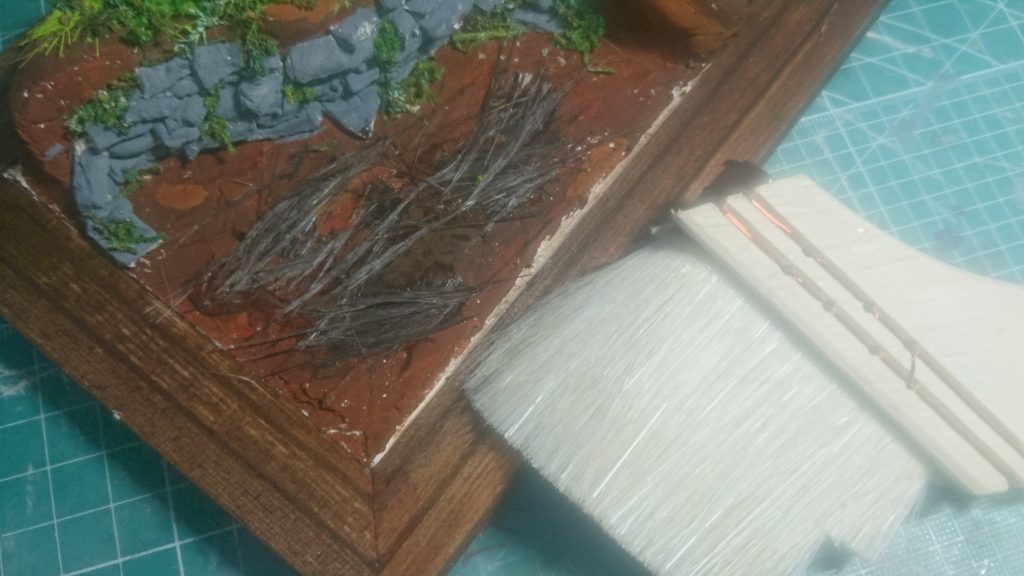 次は、枯れ木を再現します。
ハケの毛を切って黒色と茶色を混ぜた絵具に付け染めて配置します。
これで完成です。
最後に使った素材を紹介します。
石粉粘土×2
写真立て
絵具(好きな色を使ってください)
グリーンモス
工作用紙
つまようじ
万能ハケ
(その他道具)
素材は、全部含めて千円ぐらいなので是非参考にしてください。