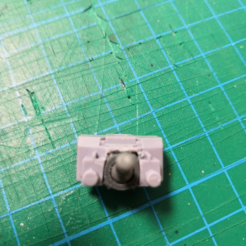 ポリキャップのダボを切って
胸にピッタリ収まるように
胸パーツの下部をノコとカッター、
ヤスリでカット。
前後ハメ合わせの背中側のカットだけで
ピッタリハマりました。
胸パーツの前後をはめ込んで
胸側の紫のパーツを下からはめれば
ポリキャップを接着やパテで
固定しなくても外れてきたりしません。
とはいえ下部のダボをなくしているので
念の為、紫のパーツは瞬着でつけました。