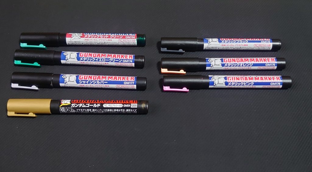 今回の使用したマーカーです。
メタグリーン(装甲、マント)
メタリックイエローグリーン(装甲、マント)
シャインシルバー(関節部、チューブみたいなところ等)
ゴールド(ボディ、ブースター、武器等)
メタリックブラック(装甲、武器等)
メタリックオレンジ(ジョイントパーツ、ダクト)
メタリックピンク(アイセンサー、武器)
スミ入れはしていないです。
そのかわり、細部にゴールドで溝の着色などをしています。