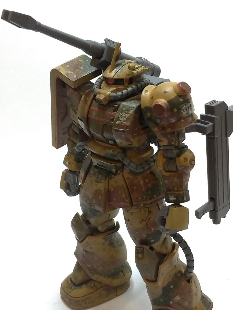 MSー06CKザク・ハーフキャノン(残党軍仕様)
一年戦争中期にヨーロッパ戦線に配属されるも、オデッサの戦いの敗退により地球に取り残された機体。
戦後は残党軍によって使用され地球連邦軍への反攻作戦に参加し、(反攻といってもゲリラ戦的なものに過ぎなかった)アウトレンジ攻撃により前哨基地などに多大なダメージを与え、時にはジムや艦船を撃破することもあった。
それに際して機体には後付けの照準装置を取り付け、敵に発見されず攻撃出来るよう、全身に迷彩を描いた。
その後はUC.0095年ほどまで現役だったが、ある作戦で被弾し破棄されてしまう。
数十年が経ち現地の人に発見された本機はレストアされある博物館で余生を過ごしている。