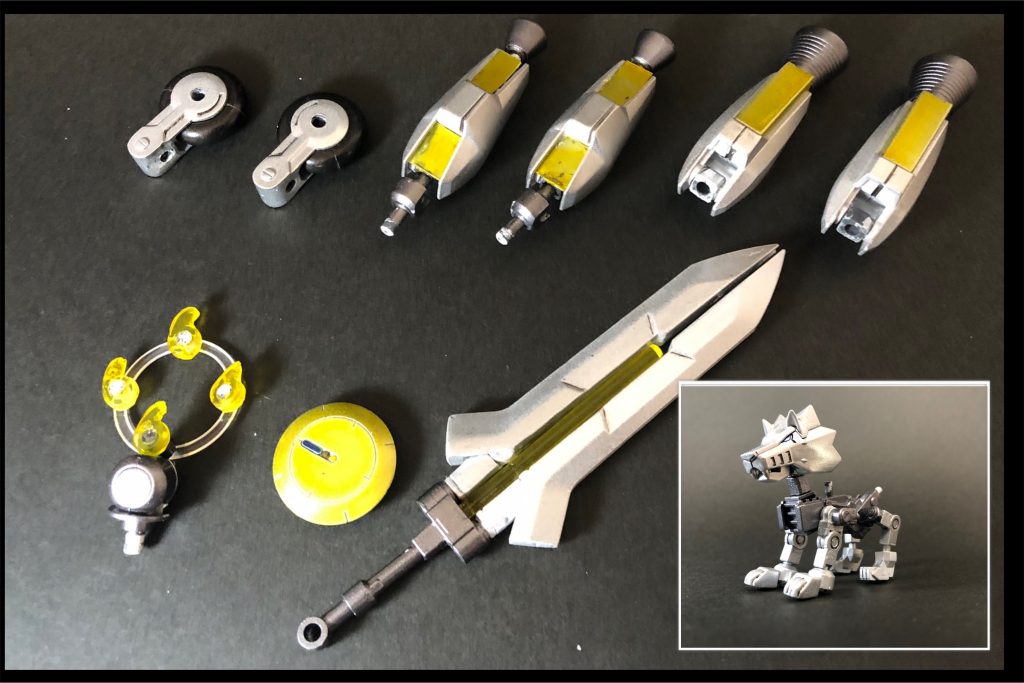 各強化装備と余剰の子犬形態ウルフを分解した状態が↑になります。強化装備(左上から)・ダッシュホイール追加分2基・テトラブースター(詳細は後述)武装、3種の神器(左下から)→勾玉、鏡、剣を模した実験的な装備。こちらも後ほど詳しく。・エネルギー結晶「マガタマ」・ビームシールド「カガミ」・大型ブレード「クサナギ」神器は3つとも外すだけで簡単に渡せるが、強化装備はウルフ本体をパーツ単位に分解する必要がある。=子犬状態になる。写真には写ってませんが、マルチビームガン強化用パーツもあります。