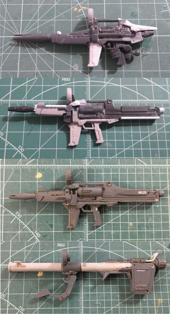 ビームライフル製作工程。・最初に作ったのはオリジナル・デザインに準拠したもの。しかし、持たせてみると“ハンドガン”にしか見えない上にバレルが大きすぎるのでボツ。大河原邦男氏の元デザインはあまりにも玩具的すぎる……。・固定射撃にはストックが欠かせないだろう、とGMカスタム用ライフルから全面的に作り直した2作目。ただし、バレルの高さがおかしかったので前部を再度作り直し。・バズーカも合わせて、色は「1/72フルスクラッチモデル」のものに倣っている。ライフルとお揃いのスコープは、ドラゴン製1/35戦車の転輪から。