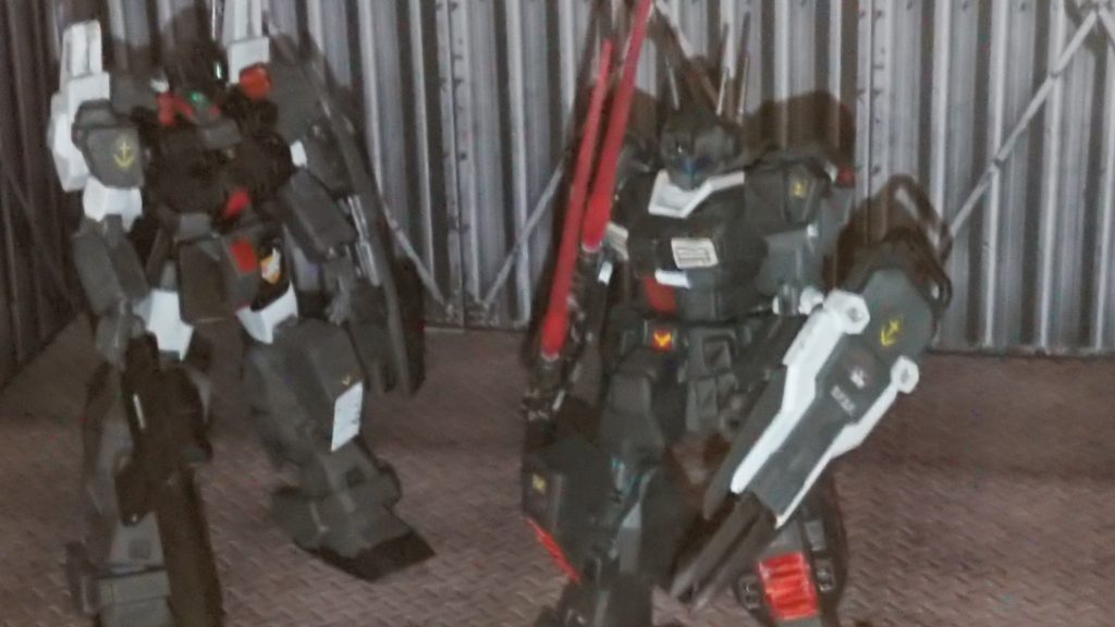 「時代はより新しくなるってのにまだこんな有り合わせでも俺等の機体を使ってくれるとはな」
その二機を見上げたとある男はタバコを吸いながらもその出来を見上げつつ,一年戦争から続くジオンとの戦争を振り返りながらも長く使っていた機体に愛着がわいているのだろうか
男は自身が使っていた機体が改修されていく様に少し寂しげに見つめていく反面,完成してく愛機を優しく見上げて微笑んでもいる。
「つぎはぎみたいな改修だが……また俺と戦おうぜ……相棒」
そう告げながらも今までの戦争を振り返った男は次の戦いに備えるべく最終チェックでの動作チェックで操縦しつつも嘗ての戦いを振り返りながらもまだ、ジオンとの戦いに目を向けねばいけないと切り替えつつもチェックを終えた後,彼はその場から静かに去りながらも「自分もまだ戦える」と闘志を沸かせながらもその場から去っていく……
「……まだ、俺は生きているんだ。共に限界まで歩もうぜ。相棒」
告げて男は機体を後ろに手を振りその場から去っていった。