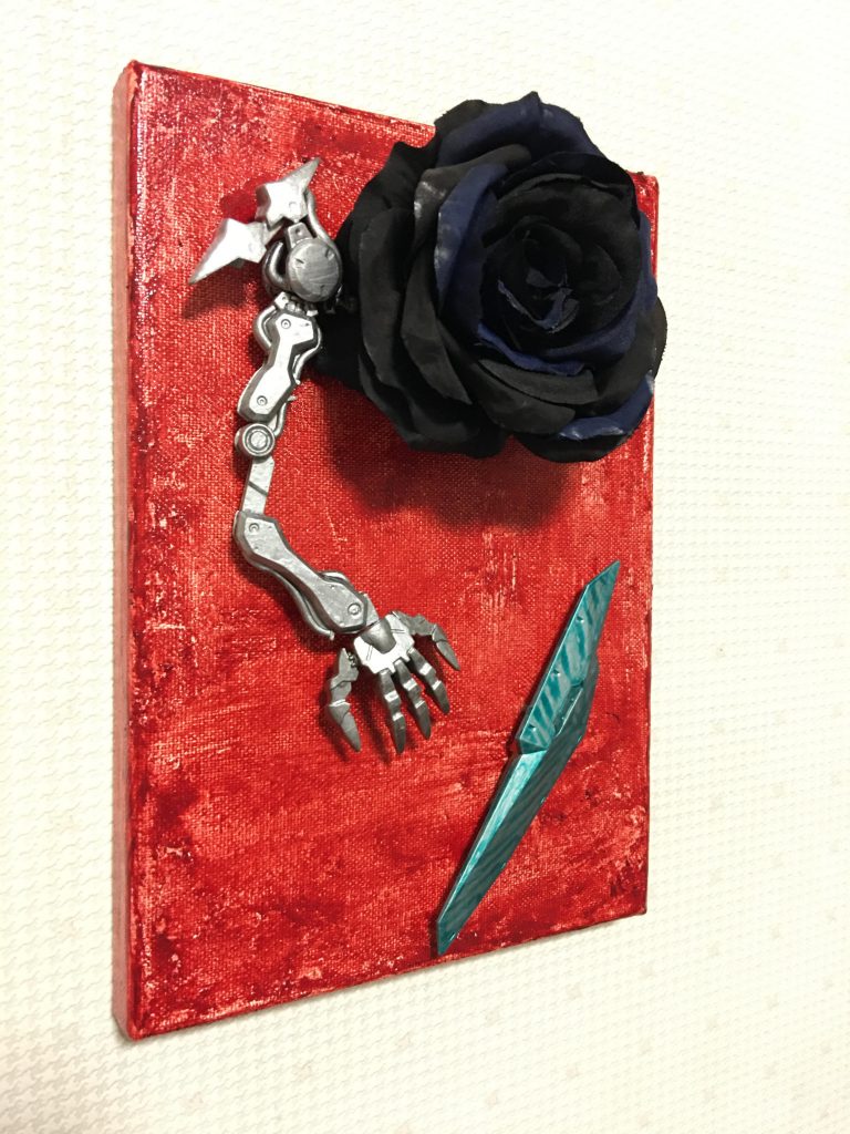 (   。・v・。)ノ 今回は「真っ赤なリボンと痛みに耐える腕」を、「黒バラと異形な機械の腕」に置き換えました(ガンダムゼルトザームの右腕です)。同様に黒い背景をシタデルカラーの「血糊」で真っ赤に変えています。