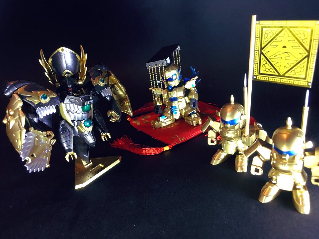 〜〜〜〜〜〜〜〜〜〜〜〜SDガンダム三国伝リスペクトのオリジナル設定『春秋戦国伝』の第十二弾です。今回は二体セットで一作品とさせて頂いています。元キットは三国伝・戦神合身蚩尤ガンダムより蚩尤ノイエ・ジールと、同じく三国伝の孫策サイサリスガンダムを使用しています。劇中、演者繋がりで孫策サイサリスが蚩尤ノイエ・ジールに取り込まれてしまう展開から両キットの合体ギミックが再現されていました。元キットの機構を活かす形でオリジナル設定化出来ないかと思案し、今回、秦の二世皇帝・胡亥が奸臣・趙高の傀儡となった様を表現する形で製作させて頂きました。
