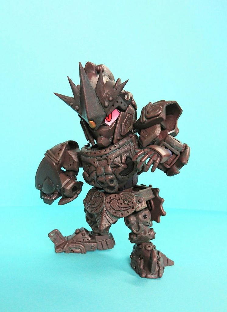 モチーフは土器や土偶です。悪の呪術士が作り出した土塊(つちくれ)の魔物【土偶羅魔神(どぐらまじん)】と戦う、神々の力を宿した器【弩偶魔戦神(どぐませんじん)】という設定です。