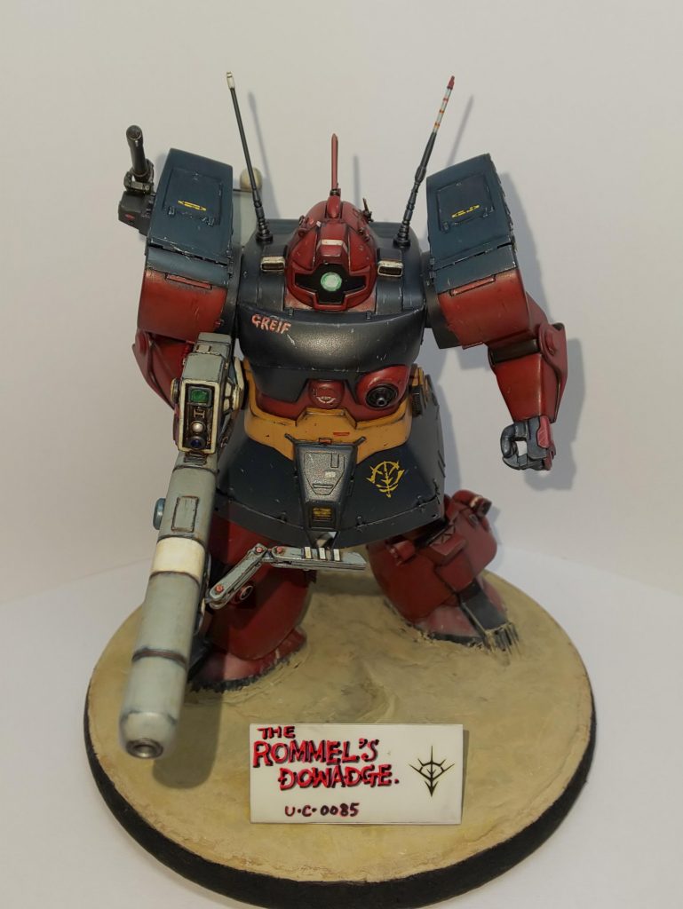 彼は、大戦時にはデザートロンメルと呼ばれ連邦から恐れられた猛将。愛機の「グライフ」を駈り大戦を生き抜き、戦後は残党軍を率いてアフリカでゲリラ活動を続けた。AFL等の民族解放組織等とも時には手を組み、0083年のキンバライト基地の玉砕時には同基地の残存兵の保護をしたり、アフリカに根付いた民間活動を支援したりとジオン再興を願い その行動には一切の迷いがなかった。しかし、0088年。クソガキどもが好き勝手に振る舞うガンダムチームとの戦闘により その身を潰えることとなる。このガンダムチーマーどもがニュータイプでなければ もしかしたら彼の理想は第二次アクシズ闘争の時に成就できたのかも知れない。