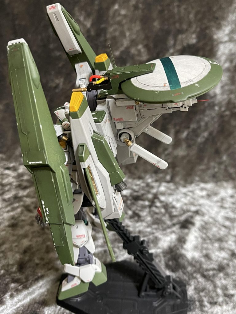 　Gディフェンサーは機首部分は使用せず、中央構造物はプラ板、棒とエポキシパテ、ジャンクパーツのカタマリです。結果、ものすごい重量に。足の裏にネオジム磁石が仕込んでありますが、鉄板の上に立たせると足腰の関節が負けて次第にのけぞっていく（笑画像では斜め後方に折りたたまれていますが索敵時は左右に開くアンテナ。レドームはガンダムウヴァルの盾を流用。表面のモールドを消すのに手こずりました。またレドーム部分は2段階にスライドします（という設定）。　Gディフェンサーもスジボリ、パネル貼りでディティールを増やしてあります。サイドポンツーンに付いてる展開する爪（降着脚？）パーツはオミット。フレキシブルスラスターは好みじゃないので普通のバーニアノズルに交換。エンジンユニット先端もネモ同様の低温化フィルターが装備されています。　サイドポンツーン上部のミサイル庫はそのままセンサーが収納されています。ミサイルハッチは大きく開いて整備性ヨシ！スペースも充分！先端の機関砲４門はオミットされずに残してあります。唯一の固定武装。 