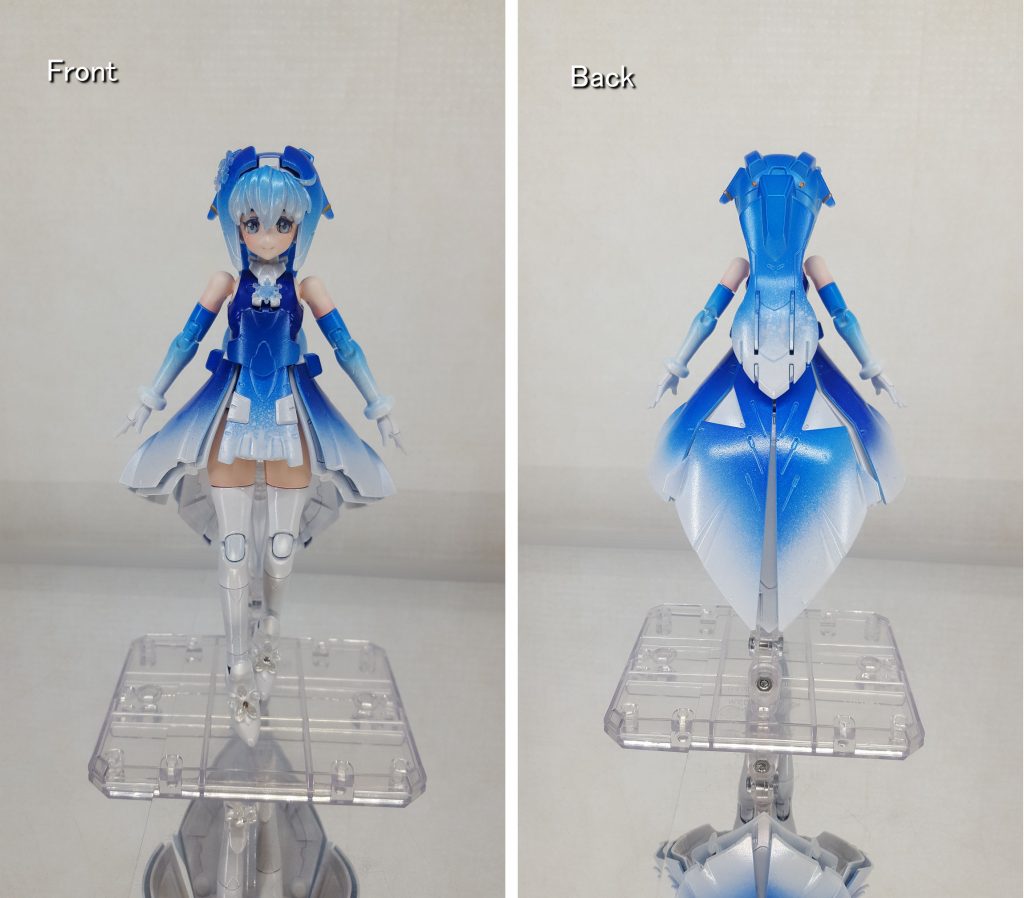正面と真後ろから。夜空と雪がテーマなので、髪とスカートは特に青と白の2層を意識しています。フロントスカートとポニテの裾部分に塗料がダマになるように吹いて、雪が降っているような表現を試みました。ちなみにお腹のパーツとサイドスカートだけパールブルーを追加しています。サイドの髪パーツの色が3層に見えるのは塗料のメーカーの違いです。途中でクレオスのクリアーブルーが尽きたので、上の方はタミヤのクリヤーブルーを使用しています。頭のブライトゴールド部分は6つの星(サラ以外のビルドダイバーズの6人)をイメージしています。・・・はっ!モルちゃん忘れてる・・・尚、墨入れはイメージが崩れそうなので行っていません。