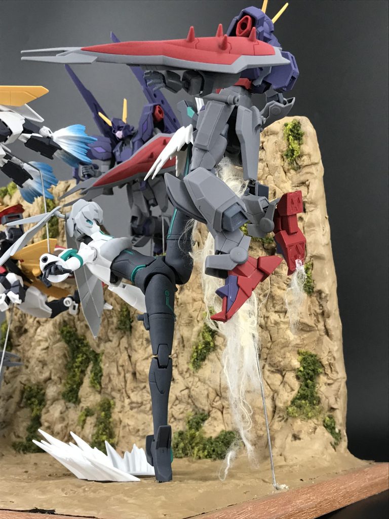 モビルドールメイとエルドラウィンダムとの戦いメイは蹴りのポーズを自然に決められるように腰パーツの左側をかなり削り込んで左脚が元キットより上に上がるようにしています。動きに躍動感を持たせるために髪の毛パーツも付け根を加工してポーズをつけてます。エフェクトパーツや色を付けた綿などを使って劇中の鋭い蹴りを再現できたかと思います。