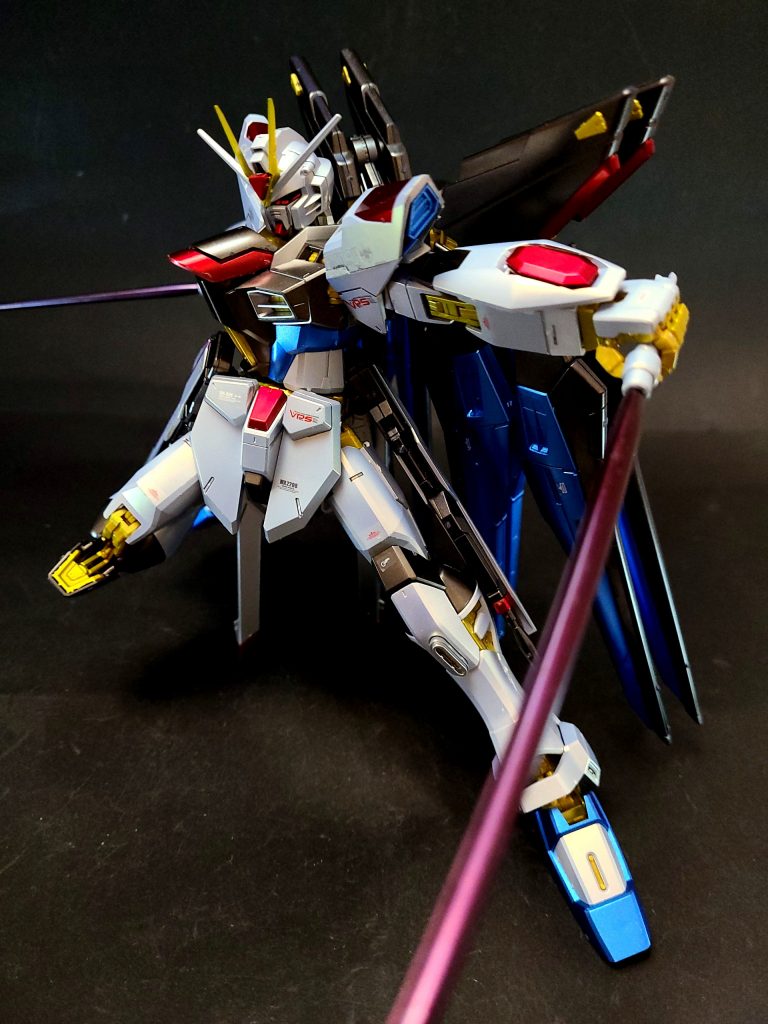 MGX-2235 カリドゥス複相ビーム砲腹部に内蔵された大出力ビーム砲。ZGMF-X31S アビスと同型の装備だが、ハイパーデュートリオンエンジンからのエネルギー供給により威力と連射性能は向上している[127]。固定装備のため機体正面にしか撃てないが、本機の搭載する武装の中でも特に高い威力、また構えずに撃てるため、乱戦などでは使い勝手が良い[110][128]。その砲口はフレーム同様の金色にフェイズシフトする。コックピット直下にこの兵装が搭載されたことに伴い、コックピットとの間を遮蔽する超高精度鏡面壁とエネルギー防壁が完備され、不測の事態からパイロットを保護している[110]。MMI-M15E クスィフィアス3レール砲旧フリーダムのM15を発展させた両腰の電磁レール砲兼AMBACユニット。砲の格納形体は従来の3つ折り式から2つ折り式に小型化されているが、威力はむしろ向上している[119]。また、M15と同様ビームサーベルラックおよびスラスターユニットとしての機能も有している。ビームライフルを両腰にマウントする際には、レール砲は後部にスライドされるため、その間は使用できない[119]。