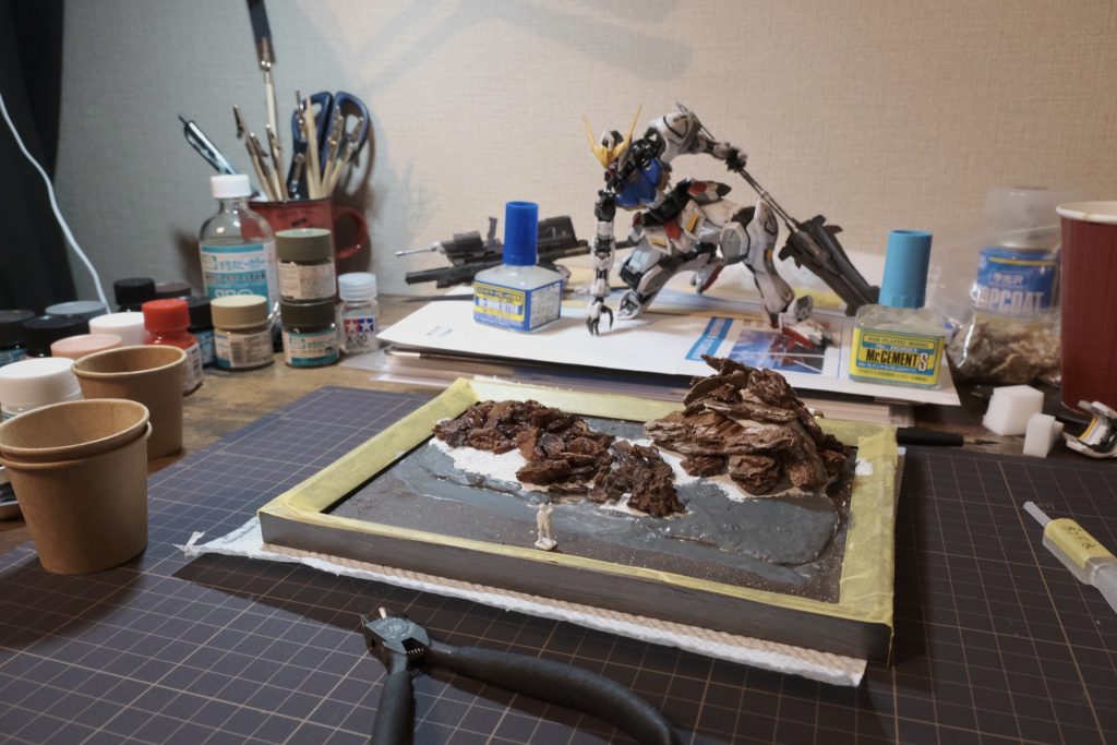 土台に関してもまったくの素人なのでネットで色々と調べ試行錯誤しました。材料は百均で揃えました。お財布に優しい。岩に見立てたバークチップの配置で悩みまくったのですがバルバトスを乗せるとあまり見えませんね。