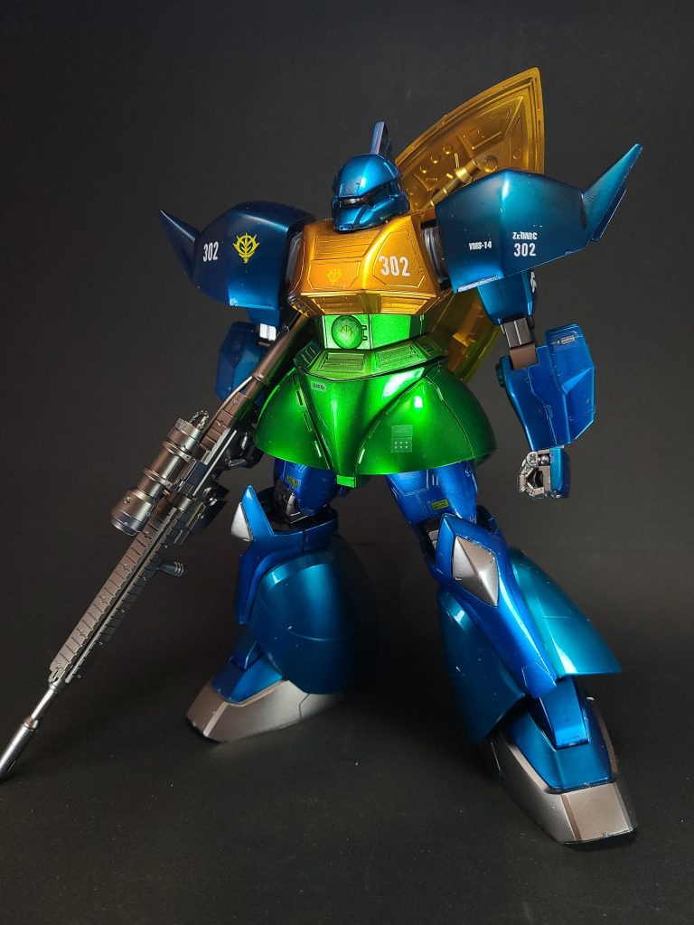 ジオン軍は量産型ザクII（F型）に代わる次期主力MSの開発に着手するもその計画が遅延していたことから、繋ぎとしてリック・ドムを採用していた[2]。ジオン軍ではMS-11の開発遅延に伴い、主力機の大半をリック・ドムとする案も出始めたため、ジオニック社は生産が中止されていたMS-06R-1Aを改修したMS-06R-2 高機動型ザクII（R-2型）に後のMS-11用ジェネレーターを搭載し、競作機として世に送り出している[3]。ただし、MS-06-R2は一部の性能こそリック・ドムを凌駕していたものの、総合性能では劣っていた[4]。その後、MS-06-R2の技術をフィードバックしたMS-11の開発が進められる。MS-11は連邦軍のRXシリーズのコンセプトを踏襲し、ビーム兵器の標準装備化、装甲の分離構想が持ち込まれた。また、11のナンバーは他の宇宙戦特殊機に移したため、途中から型式番号はMS-14に変更された