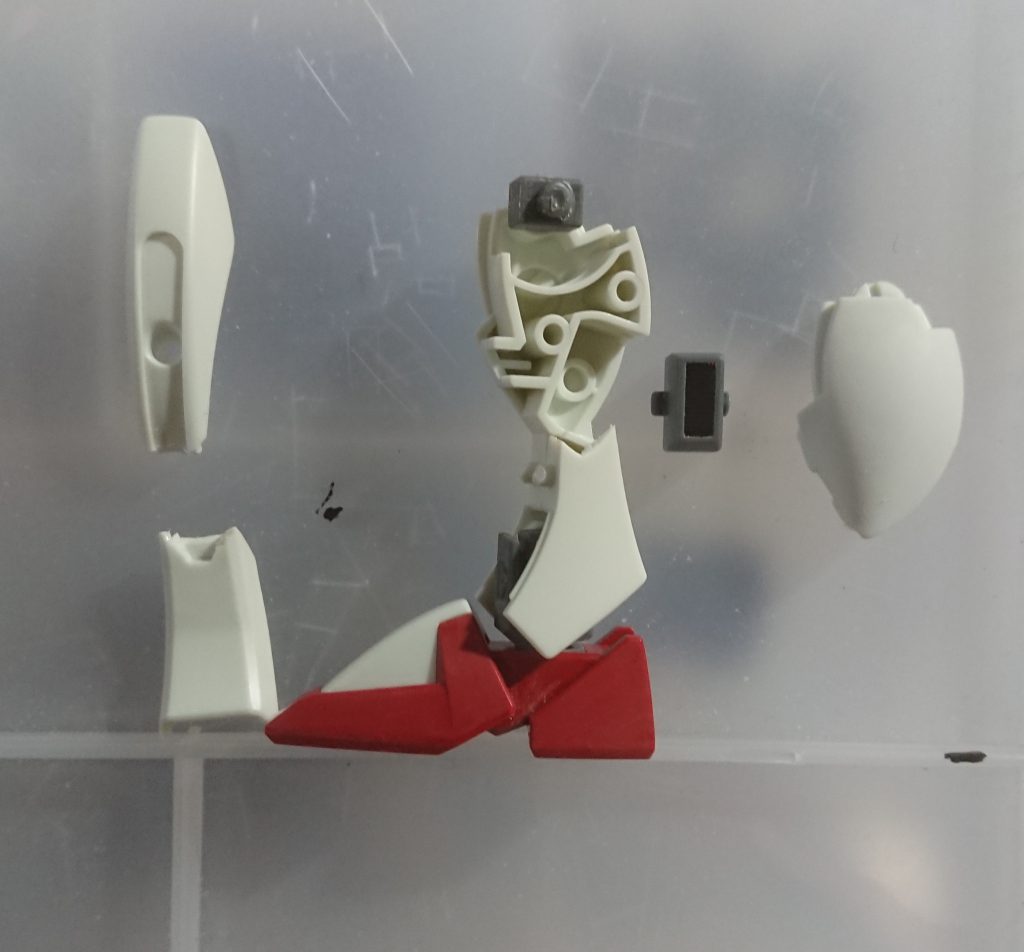 脚部は側面に結構豪快に合わせ目が出る上に、そこを接着するとバラせない構成だったので、画像のように分割して後ハメ加工。曲線的に切断するので割と面倒ではあります。バーニアパーツのダボピンを片方短く切っておくと入れやすくなります。