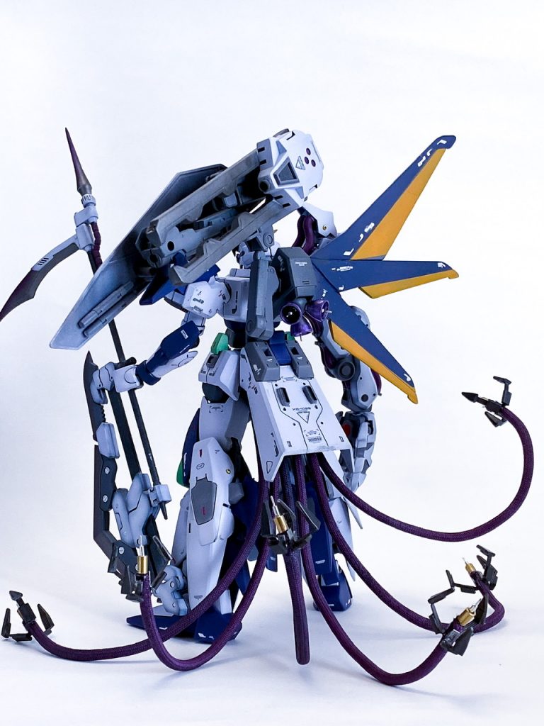 背面。リアスカートは重たげな形状ですが、何かを格納するコンテナに見立てられると思い、メイン火器となる有線式クロービーム砲をにょろにょろ生やす基部にしました。バランスが悪くてもケーブルを支えに自立できます。ちなみにクロー部分は、プロモデラー林哲平さん考案の林指という物です。プラフォークとホチキスの芯で簡単に作れました。