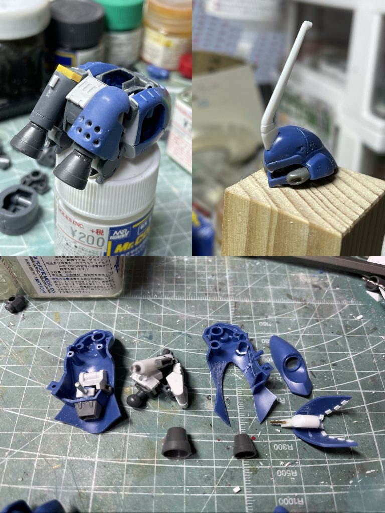 設定を強化・補足する方向で解像度を上げる改造をしていきます。背中は装甲は無く、推進用のロケットモーターが剥き出しの状態。わずかに遮熱板のみで覆われています。部品運搬時の軽量化・資源レス・組み立て工程の簡略化などなど、背面はとにかく装甲レスで。頭部もひさし部分中央に三角の突起を付けて目つきが鋭く見えるようにしました。耳のダクトは社外品使用で大型化。ツノもプラバンで大きく作り直し強そうに。カブトムシ的な。今回のキモは脚部。ロケットノズル周辺の装甲を切り取り展開するようにします。おかげで関節のポリキャップを繋ぐダボがすべて無くなってしまいフレームから新造するハメに。ジャンクパーツを使用して脚部フレームと横・後方のロケットモーターも別パーツ化。左右の脚を対称に作るのは大変でした。できるかぎりユニット構造のようにして左右対称となるように。高機動を担う脚部ロケットモーターはコンパクト。固形燃料をもとから封入した使い捨てブースターをイメージ。