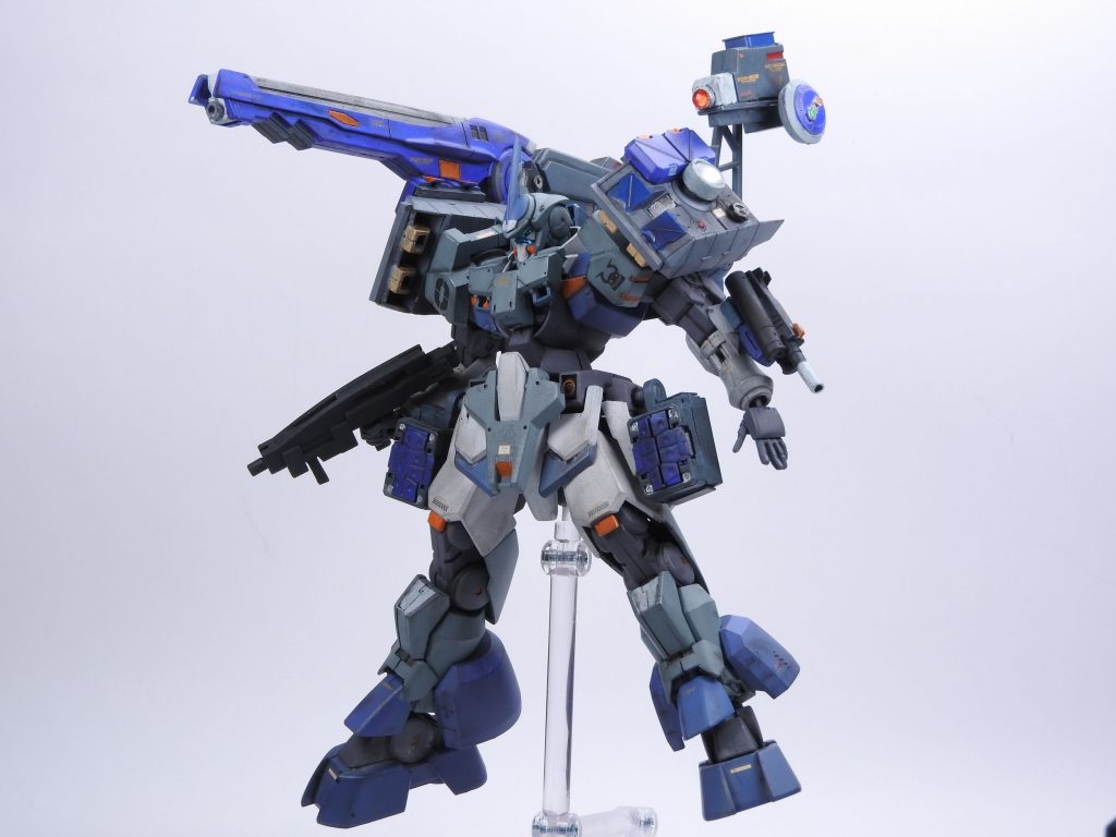 換装装備①GNX-600A  ゼロジンクス・アーセナル背部のGNランチャーに特徴のある青い砲戦仕様の換装ユニットです。腰部にマウントされたGNマイクロミサイル、左腕部にマウントするGNハンドカノンを背部に装備した射撃管制ユニットで制御し、中遠距離での砲撃戦に於いて高い制圧力を発揮します