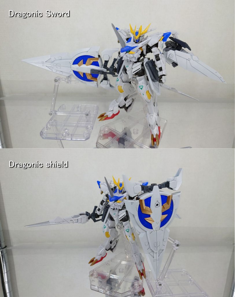 【武装3】・ドラゴニックソード / ドラゴニックシールドジオニックソード改め、ドラゴニックソード。試作型相転移式斬甲剣の柄をウイングユニットに接続することで大型バスターソードとなる。刀身部からエイハブウェーブを放出し、接触した対象の振動係数を狂わせて砕き斬る。全体的にナノラミネートコーティングを施しており、ビーム兵器に対して高い防御力を誇る。また、ナノラミネートコーティングの特殊塗料は衝撃にも強く物理防御も高い。剣中央のグリップは、シールドとして使用する際に持ち手となる。ジオニックソードを色変更した物です。スラスターはデフォルトの仕様だと左右にしか向きが変わらないため、縦に回転する軸を追加しています。グリップは剣中央の3mm軸に取り付けました。デフォルトだと片側にしか穴が空いていないため、反対側にも3mm軸穴を作りました。尚グリップを取り付けたは良いものの、胸のドラゴンヘッドが邪魔で両手持ちができません。※デカすぎて片手持ちがきついです。