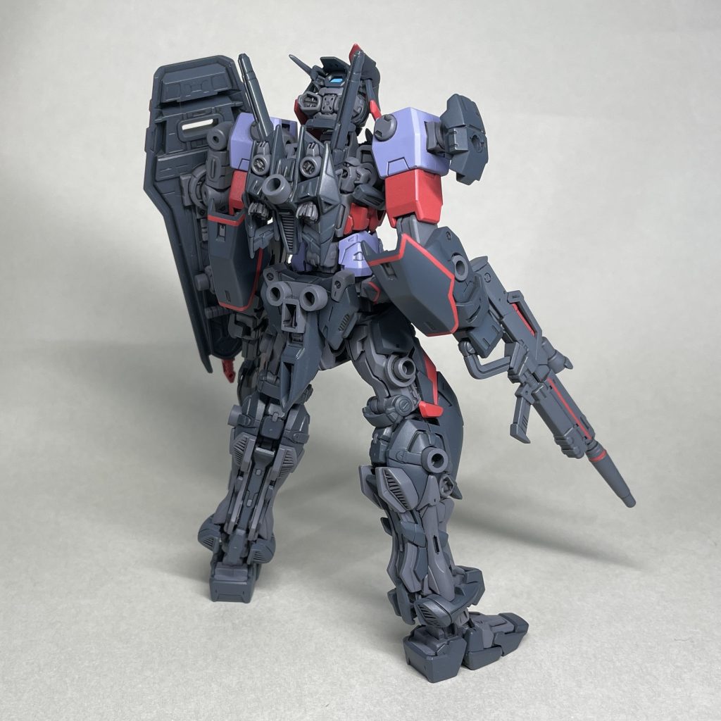 うしろ 腕追加装甲、腰サイドアーマー、シールド、ライフルの赤いラインは、下地にピンクサフを吹いてから赤で塗装し、ライン部分をマスキングしてから念のためクリアーを軽く吹き、本体の濃いグレーを吹いて塗り分けました。