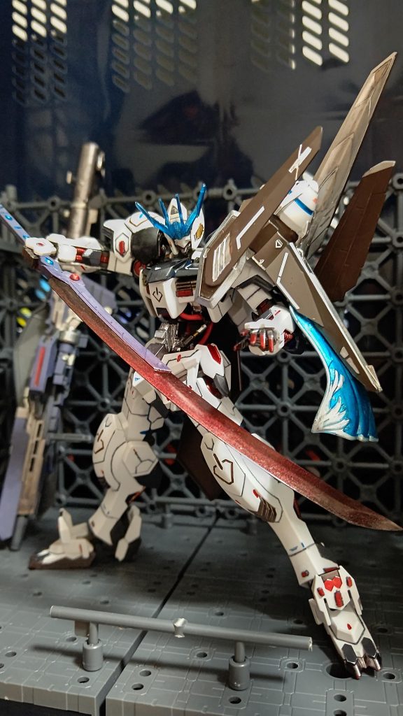 この機体のもう一つのメイン武器になります。大太刀「黒椿」です。本来の太刀だと短く感じたので柄はそのままで刃部分だけ別のパーツに変更しました。このぐらいだとMSもフレームごとイケる!気がします。塗装はガンダムマーカーエアブラシでガンダムマーカーブラックを吹き、よく乾かしてガンダムマーカーEXロイヤルメタレッドを吹きました。あまり吹きすぎるとただの赤い太刀になるのでここは気をつけました。最後にガンダムマーカークリア光沢で仕上げました。