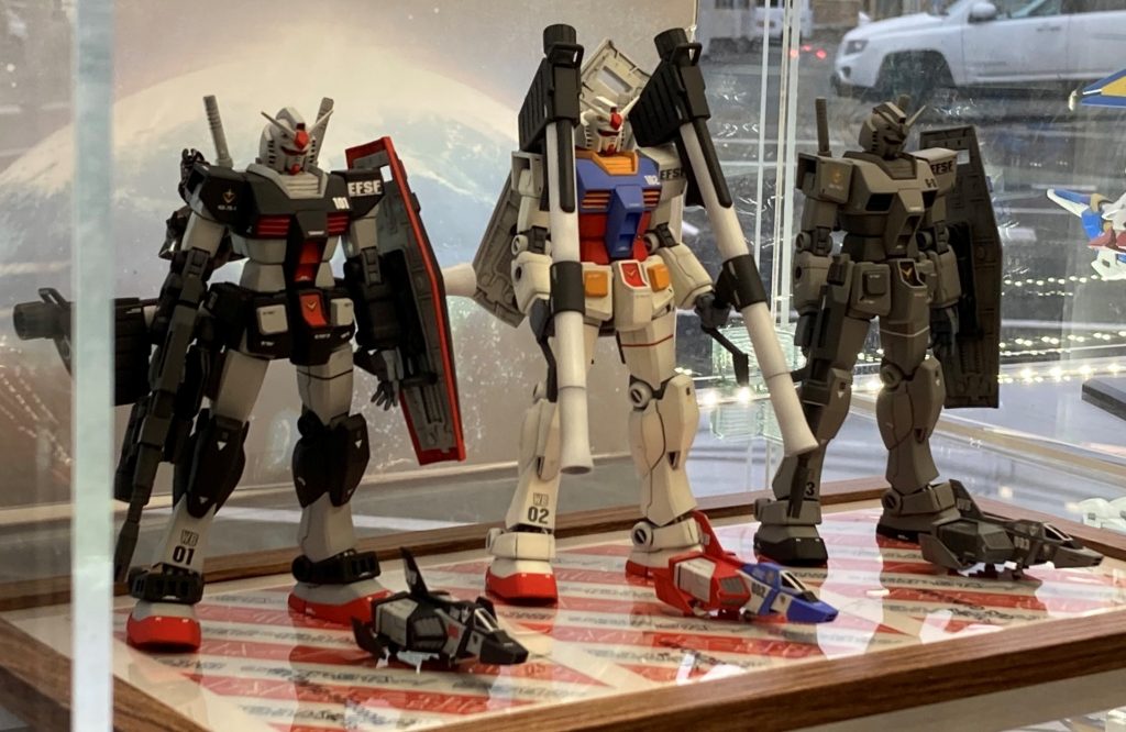 プロトタイプガンダムは、シバタモデルで買った思い出の旧キットMSVシリーズのプロトタイプガンダムのオマージュ。78-2は、シバタモデルで最後に買ったプラモデル。G-3は前の2機に続いて、シバタモデルの意思を引き継いで続いていくように、という思いを込めています。台座はシバタモデルの包装紙をスキャンしてサイズを調整し、機体名を入れて、フォトフレームに入れたものです。