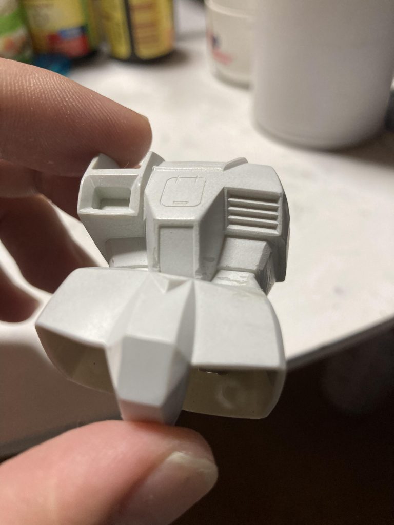 左肩を切り詰め加工し、胴体胸部と腰を1度切り離してから曲げる角度を決めて繋ぎ直し、足りない胴体部をパテで盛って削って成型しました。