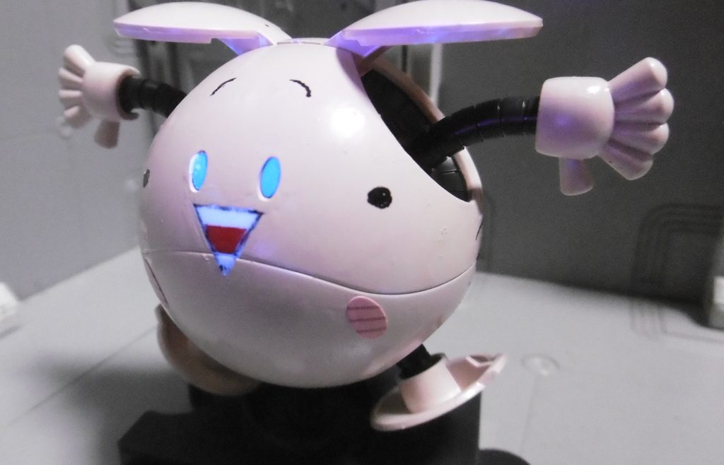 へろへろくん最大の特徴の1つ『鼻水芸』ヘロの場合、サイコ・ハロのあの兵器(目からビーム出るアレ)と同じように、きっと熱量の高い何かが撃たれるのでしょう。内部メカに蛍光クリアーを塗って表現していますが、このハロ成型色の白は素でブラックライト反応するようで、無塗装部分の歯まで一緒に光ってしまうのです。