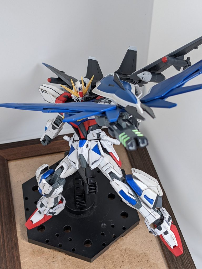 シールド!本機最大の特徴として、ウィング型粒子吸収機構兼広範囲防御面を装備したシールドを持たせました。ウィングはビルドブースターから。これが粒子を集め、腕部を通してビームライフルに送られハイメガキャノンに近い威力を放てる必殺技!本当はウィングガンダムみたいに銃盾合体にしたかったけど、ビルダーレベルが足りませんとメッセージが出たので諦めました。何が見えてんの・・・?ただ、ウィングまわりの仕上げが汚いですね。やっては失敗しやっては失敗しの繰り返しで心が折れた結果です笑ってやってください。白の塗装は比較的できるようになってきてはいるので、もうしばらくしたら仕上げし直してみようかなとは。