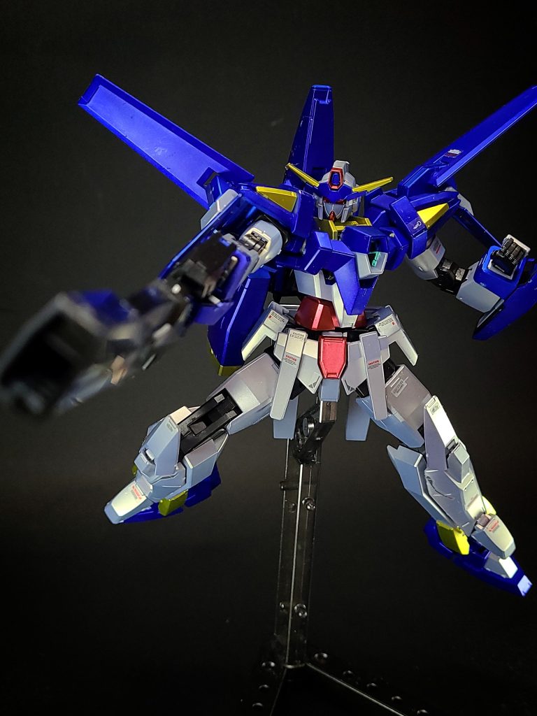 武装・必殺攻撃シグマシスライフル大口径の携行式ビーム砲。使用する際は逆手に持って使用する。ディーヴァのフォトンブラスターキャノンの技術を応用して開発された武装で、レガンナーを電磁装甲ごと一撃で破壊できるなど従来のMSの武器を大幅に凌駕する威力を誇るが、その一方で整備性は低い。非使用時は背部にマウントされる。ブラスティアキャノンシグマシスライフルにAGEシステムが製作したバレルを追加した状態。これはフォトンリング・レイの小型版と言えるもので、ヴェイガンの新型飛行母艦を一撃で撃沈する程の威力を持つが、威力が高すぎて使いどころが限定される上、チャージに非常に時間がかかる。また、少ない戦闘データで無理やり造り出した弊害で追加バレルの耐久性は高くなく、1発撃っただけで砲身が自壊してしまった。後に強化改修されたガンダムAGE-FXのスタングルライフルのチャージモードへと発展している。