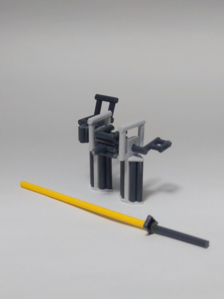 ストライカーパックを付けることで汎用性を持たせるという設計思想のストライクガンダムは本体バッテリー容量が他の4機に比べて少なく、運用テストが難航していた。そこで、バッテリーを備えたテスト用パックが有り合わせの機材で急造された。「バッテリーパック」と名付けられた本装備は、円滑なテスト運用のため基本武装であるビームライフル、シールドのハンガーを備え、肝となるバッテリーは特別な施設がなくともストライク本体による交換が可能であった。また、ソードストライカーのシュペルトゲール、ランチャーストライカーのアグニなど偏重心となる大型武装を装着した場合のバランスチェックのため、大型ヒート・サーベルが追加された。数回の使用で焼け付く試作品ではあったが、ザフト製MSの実体剣には有効であったという。…といった脳内設定です。