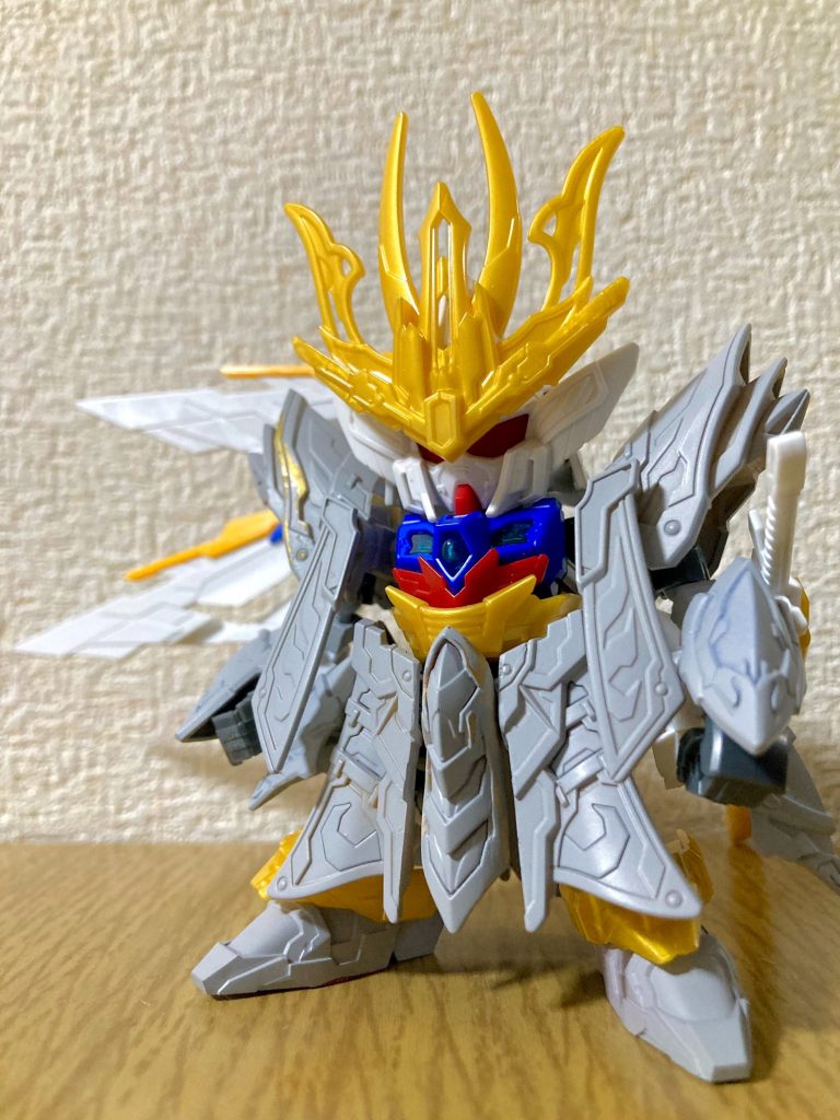 デザインは三国創傑伝の曹操ウイングを一部基調としつつも、ほとんどが新規パーツで、信長エピオンの装飾にも構成が似ています。モチーフ演者は従来のウイングガンダムゼロEW版よりもトリコロールカラーが特徴的なアーリータイプのウイングガンダムEW版(Ver.Ka)に回帰する傾向が見受けられ、左右非対称に寄せた羽根のシルエットはウイングガンダムフェニーチェも彷彿とさせます。