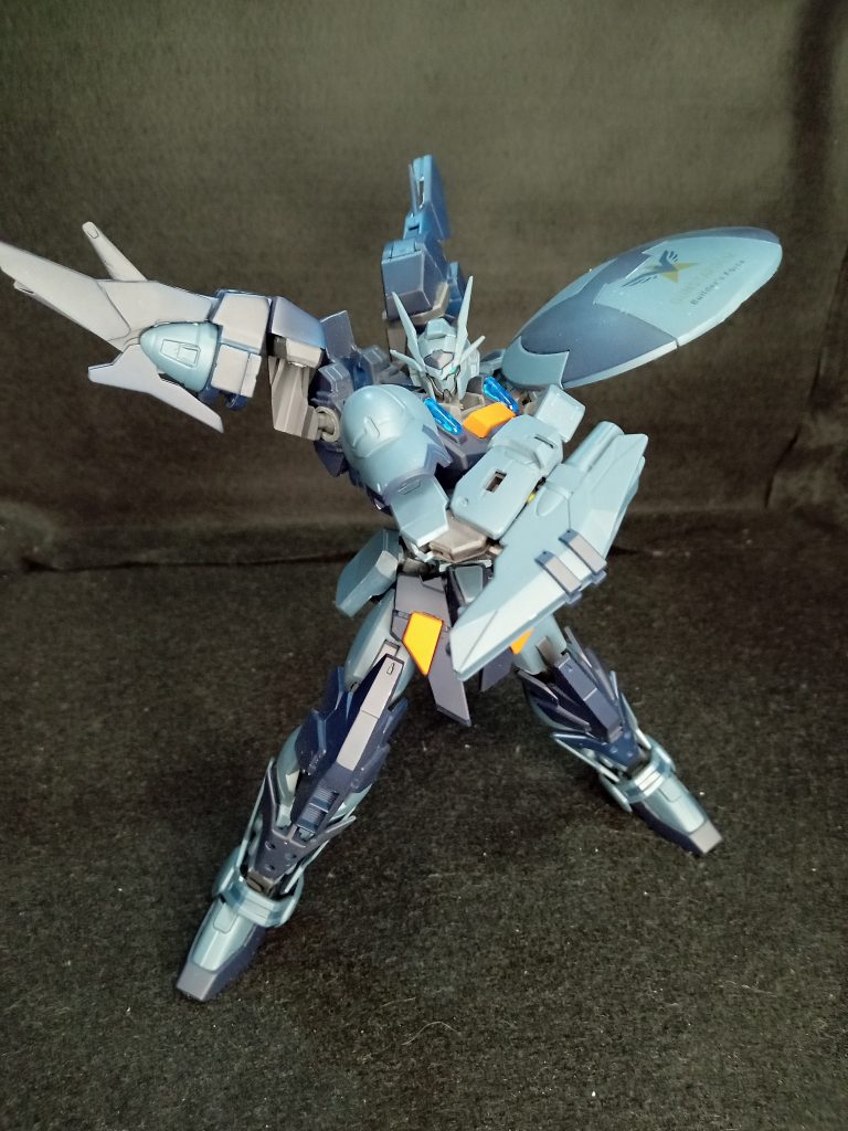 GNシールドを装備。シールド自身も強固であるが、GNフィールドを展開することで広範囲を守ることができるだけではなく、シールド自体の防御力も上げている。その強固さから打突・斬撃・シールドバッシュなど攻撃にも転用できる。また、GN粒子により投擲した後でもビット兵器としての運用も可能である。