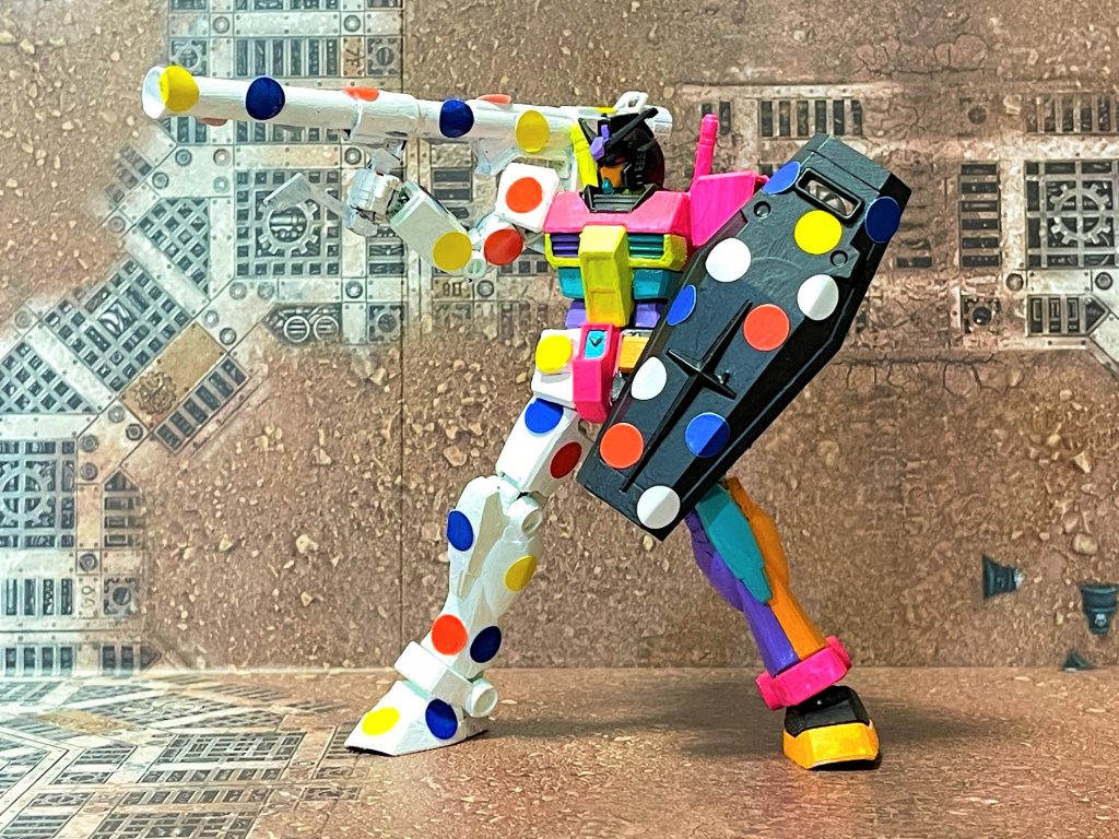 ( 。・v・。)ノ 右半身とシールドは一色に塗ったあと、ガンダムでおなじみの「トリコロールカラー」を、印をつける際などに使われる「丸シール」で表現しています。逆に左半身は、ガンダムの世界では異質とされるような蛍光色などを使ったサイケデリックなカラーリングにしています。全てアクリル絵具による筆塗です。