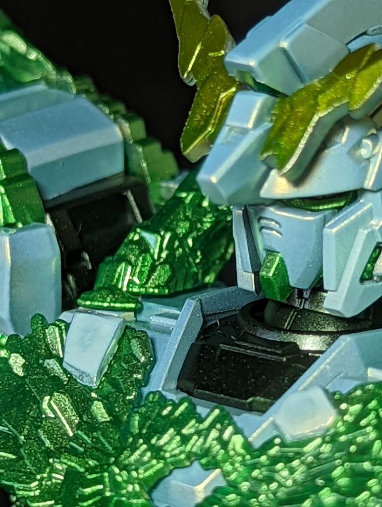 両肩の結晶体にはガッツリと肉抜き穴があったので、お湯マル君で型を取り、クリアーグリーンのランナーパテで結晶体模様を複製して、肉抜き穴部分に合うよにカットしてはめ込んでいます胸の2ヶ所と両肩のシール処理する箇所は、プラ板やお湯マル君で型取りしたランナーパテでパーツを作って塗装後に両面テープで貼り付けてます腿のつけ根、両肩アーマー、両肘の装甲部分、足首のつけ根等、2018年9月号ホビージャパン誌掲載の記事を参考に塗り分けています