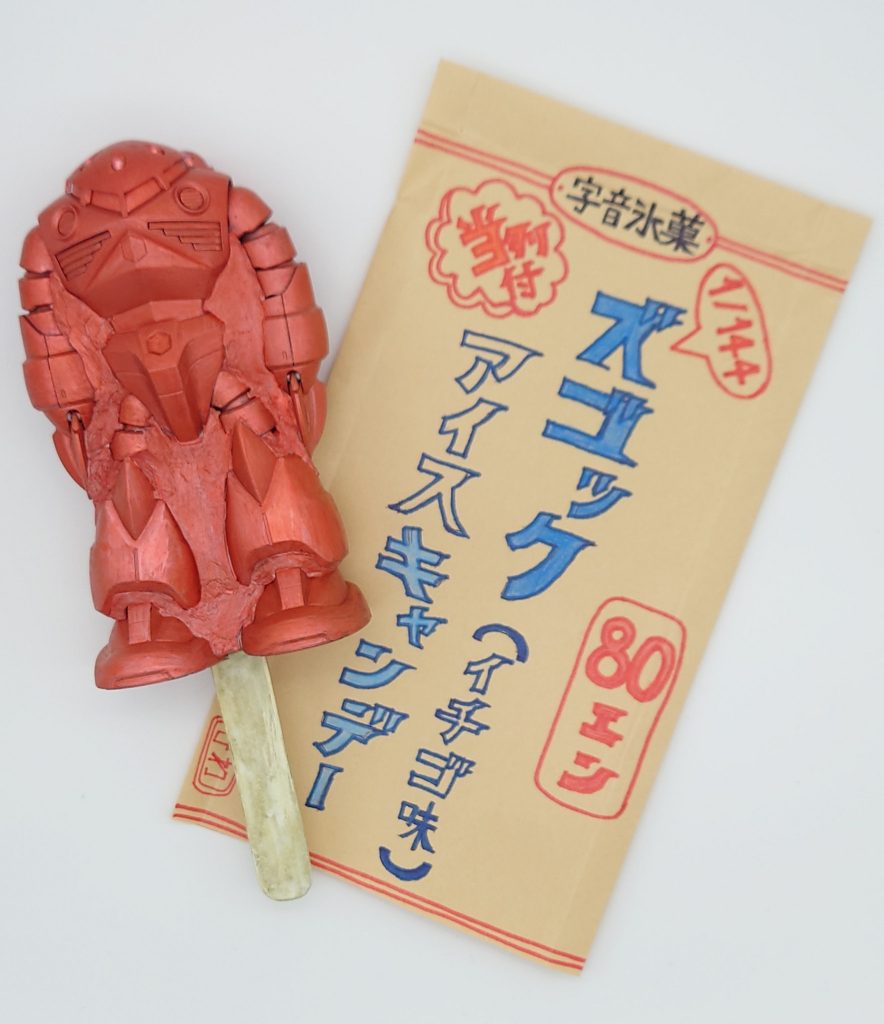 さあ買った！買った！今なら赤い彗星ブロマイドも付けちゃうよ！そこのアンちゃん！寄った！寄った！／ジャブローの寅