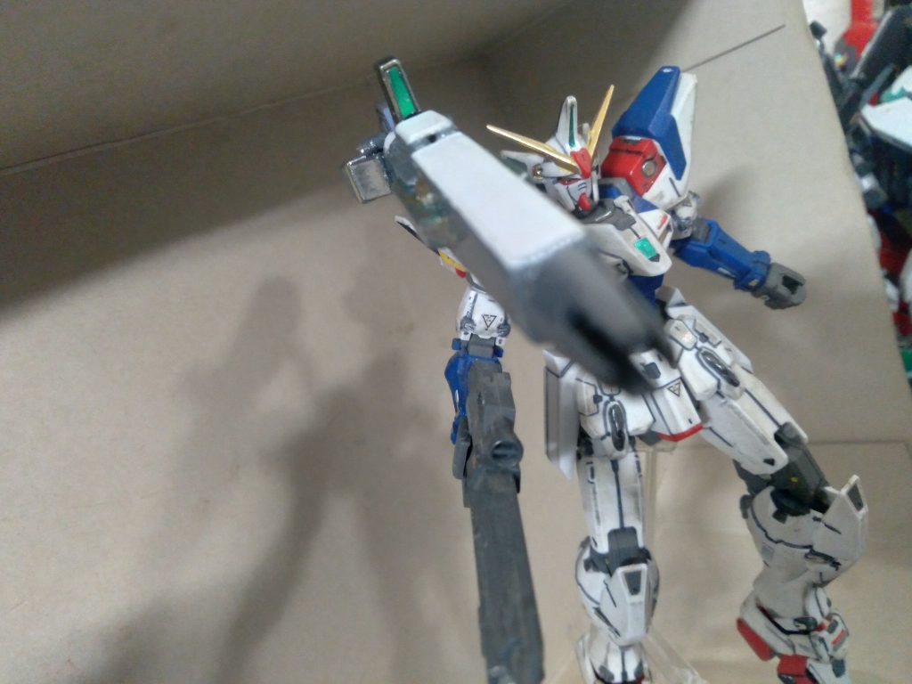 The in-universe description is this. The hybrid beam cannon uses electricity to charge an accelerator that forces Minovsky particles to fuse. The resulting fusion creates an enormous surge of energy. When channeled through the barrel, electricity gives the particles one last jolt, sending them out there barrel 