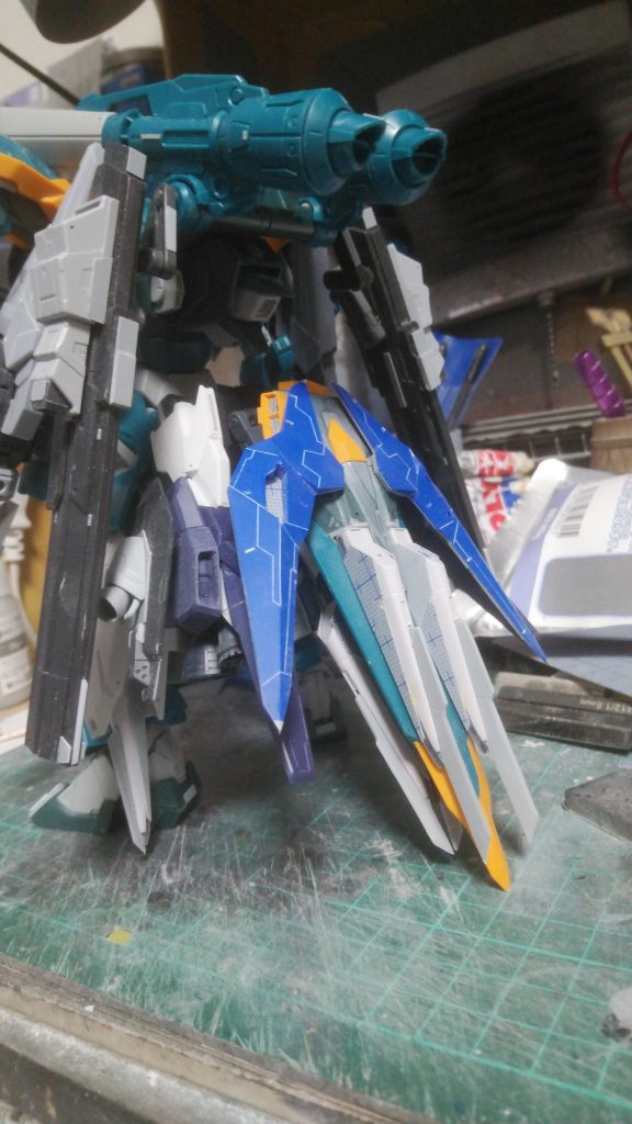 シュラーク側面の武装は、境界戦機のウェポンセットのジョーガンのライフルです。トラグーンは、フェイクニューのファンネルを全部切り離し、プラバンで形状変更しました。プラットフォームはカラミティの盾です。腰部の大型ブースターは、まんまトライエイジの脚部を使ってます。