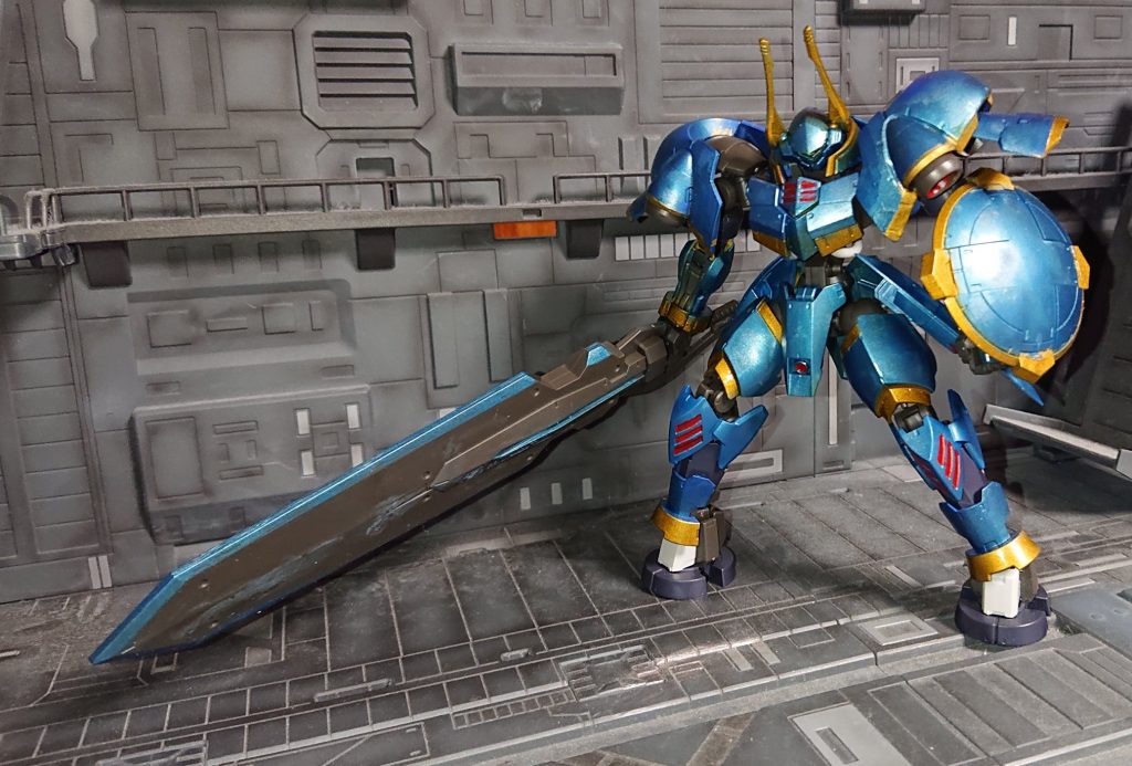設定ガンダムフレーム・マルコシアスヘルム（過去作参照）での戦闘データを反映させた対MA用強化型ヘルムヴィーゲ片手での大剣術に加えラウンドシールドを装備腰にスラスターユニット 