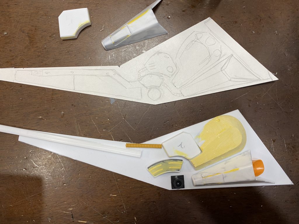 厚紙にグライバインダーのラフスケッチをしてそのような感じでパーツを作っていきます。3Dプリンターがあればなぁ…