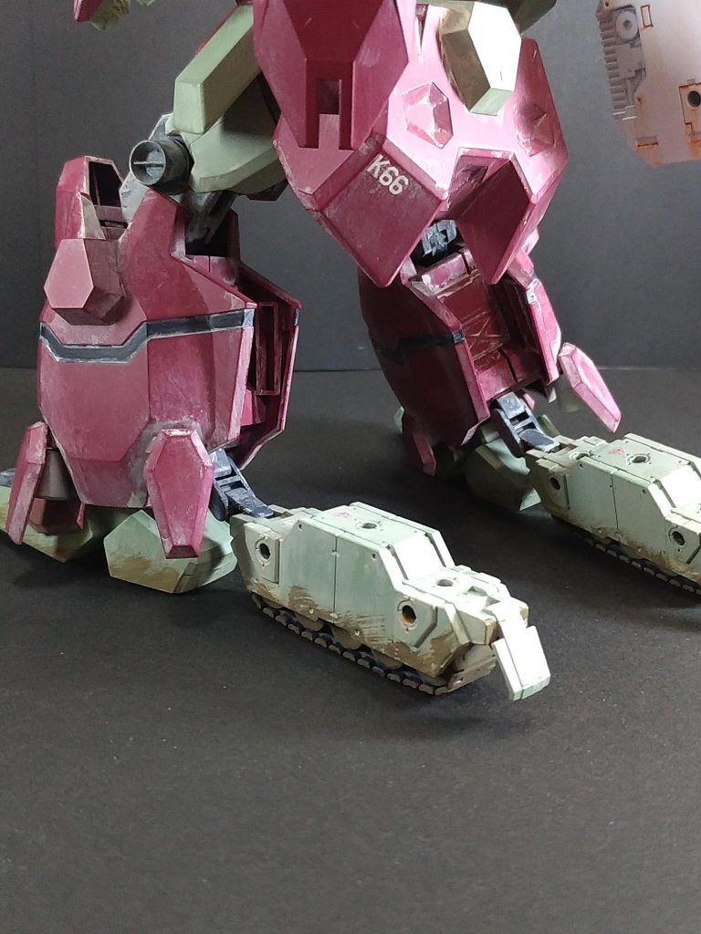 運び屋仕様にするために脚に履帯を装備させて長距離･高速移動に対応させてみました。通常は二足歩行、高速移動時は足裏とふくらはぎの履帯を展開する形をとりました。背中の中央にグスタフ(ゾイド)のGPS複合センサーに似せたアンテナを設置。右側には可動アームを追加し、30MMのコンテナを装備させました。腰がほとんど動かないので、延長パーツを製作して可動範囲を広げています。