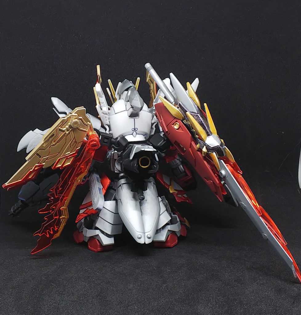 背面左側の金色の翼は焔竜の神器の物右側の羽は彼の兄弟子に奪われ、現在も行方不明「金色の羽を持つ竜剣士」を探し旅をしている