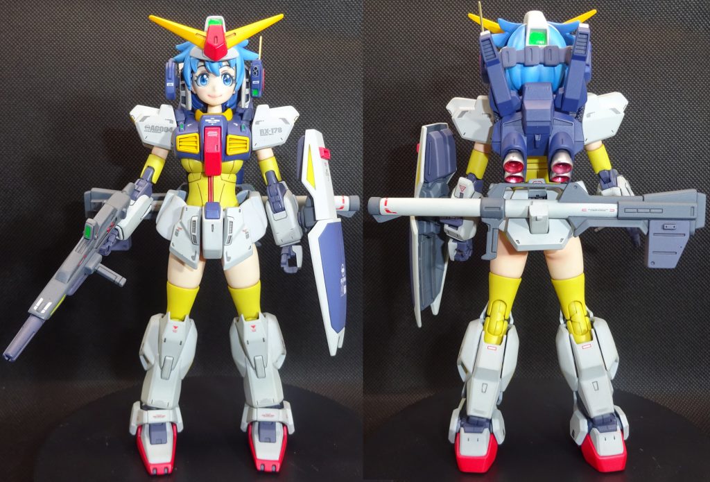 フル装備の前後ショット　スリッパのつま先と踵を小型化したのは意外に効果的だったかな？と思います(^^ゞ　最初は脚部も、ふくらはぎなども小型化して丸味を持たせようかと思っていましたが　仮組段階で意外にしっくりきたのでｃ面を強調するだけに留めました　胸部アーマーはフィッティングのために一度切り刻みエッジを落としてプラ板やパテで再構築　赤いコックピットハッチ以外は全体に丸味を持たせてます　塗装は全体に設定色より明るめの色でポップな感じになるように塗り分けました　フレーム部分だけパープルを多めに混ぜ暗めにしてます　武装類はひたすら丁寧に継ぎ目消しと面出しして綺麗に塗り分けただけです