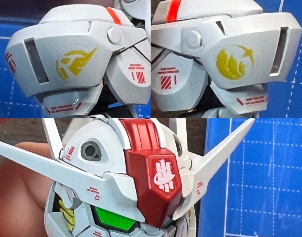 シン・セーのロゴとホルダーと地球寮の自作デカールを制作して貼りました。シールドにもシン・セーのロゴを貼りました。シェルユニットについて頭部は蛍光塗料を筆塗り・胴体はインモールドパーツを使用・太腿バックパックはHG付属のホイルシールを使いました。